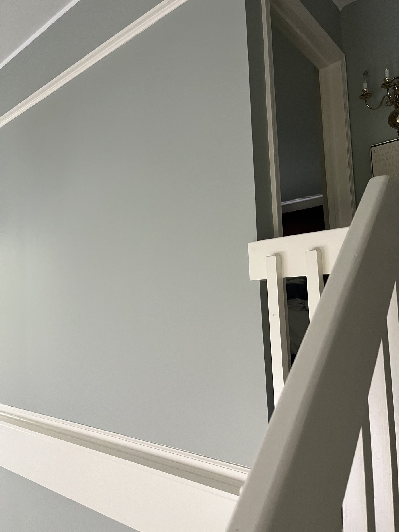 Interior stairway painted in a soft blue-gray with white chair rail in Upper Arlington, OH